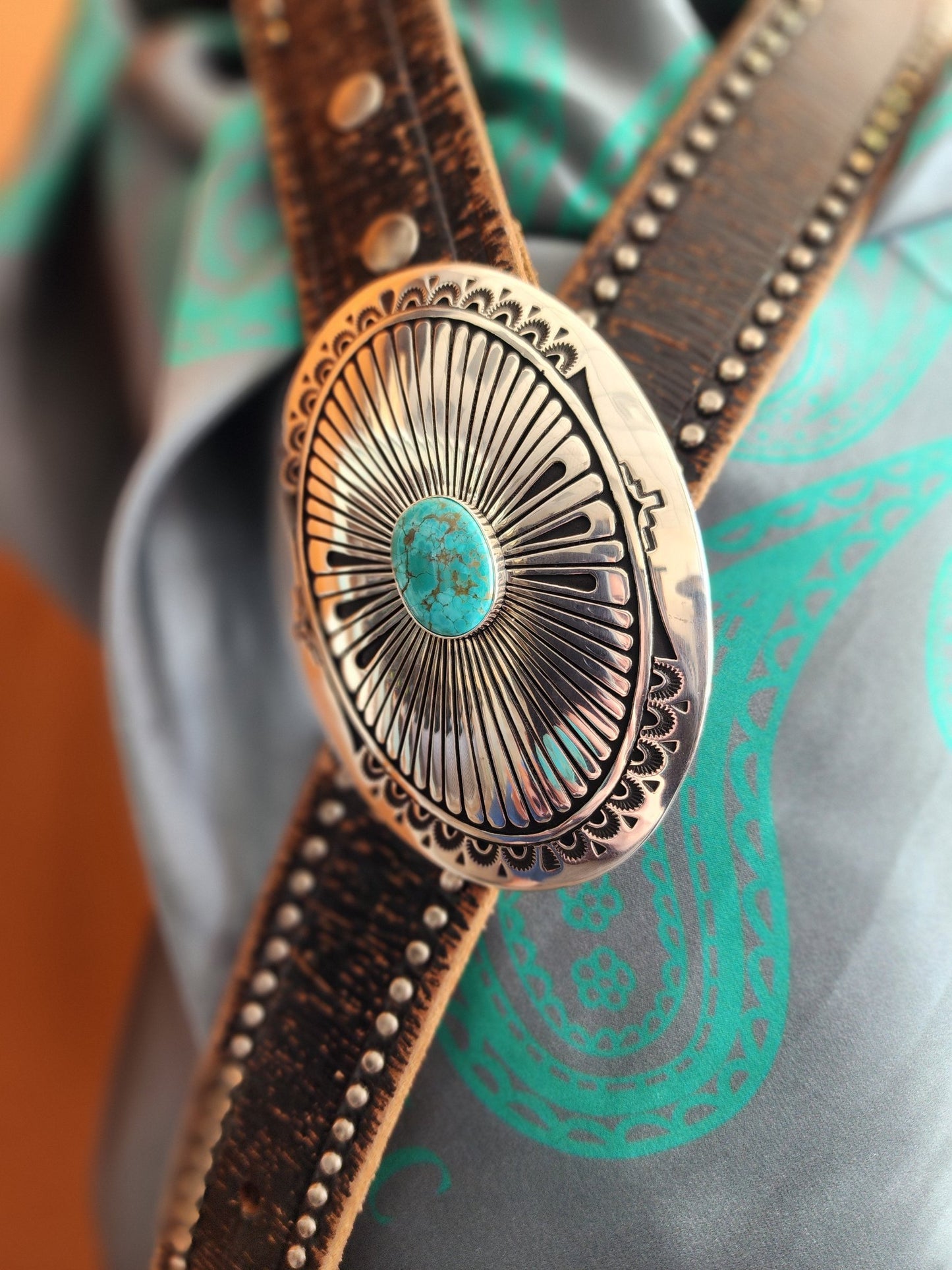 Hand-stamped Sterling Silver belt buckle with Lone Mountain Turquoise stone accent paired with a brown leather belt