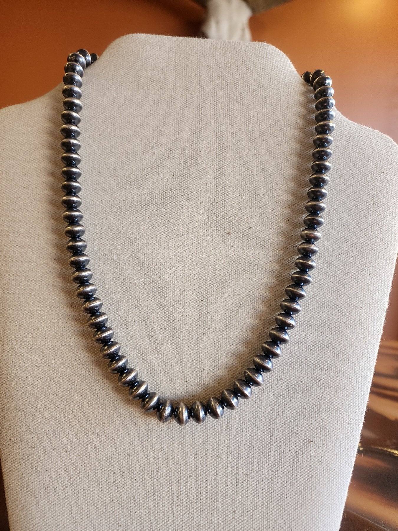 Single 9mm Navajo Pearl necklace in Saucer Style on display