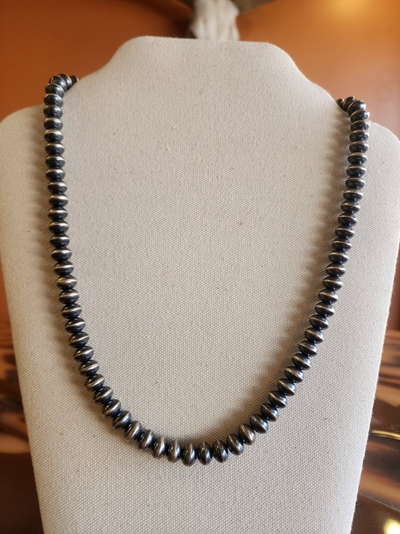 Single 9mm Navajo Pearl necklace in Saucer Style on display