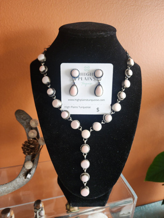 Pink Conch and Sterling silver necklace and earring set on display