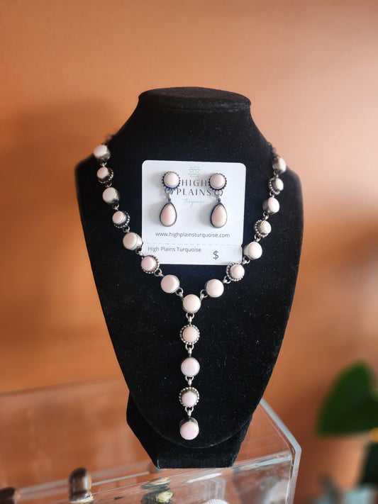 Pink conch and Sterling Silver necklace and earring statement set on display